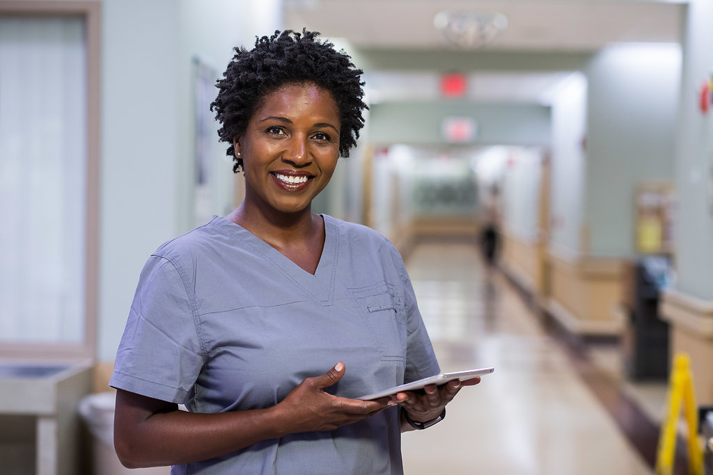 Nurse holding tablet.